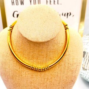 Beautiful vintage gold tone Monet tubular, curved collar necklace.